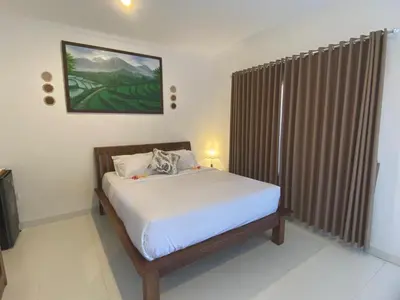 a bedroom with a bed in a room at Manis Guest House in Seminyak