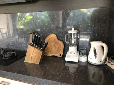 a kitchen counter with a blender and a knife block at Big 3 bed, to BatuBelig Beach, last min specials in Kerobokan