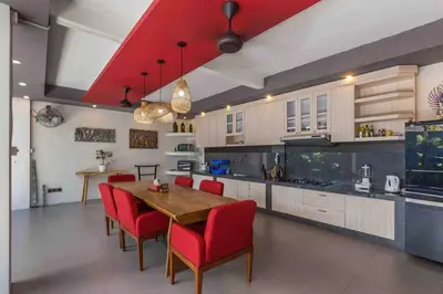 a kitchen with a wooden table and red chairs at Big 3 bed, to BatuBelig Beach, last min specials in Kerobokan