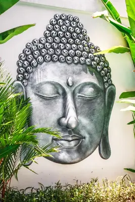 a painting of the face of a buddha at Villa Blue Water by GORO in Seminyak
