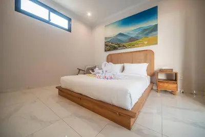 a bedroom with a large bed with white sheets at Villa Semangka, Seminyak Umalas in Kerobokan