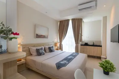 a bedroom with a large bed in a room at Bali Bustle Pararaton Coliving and Coworking Space in Legian
