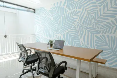 an office with a desk with a laptop on it at Bali Bustle Pararaton Coliving and Coworking Space in Legian