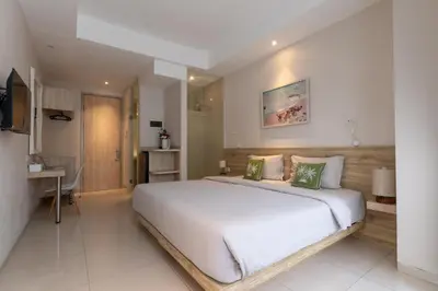 a bedroom with a large white bed in a room at Bali Bustle Pararaton Coliving and Coworking Space in Legian