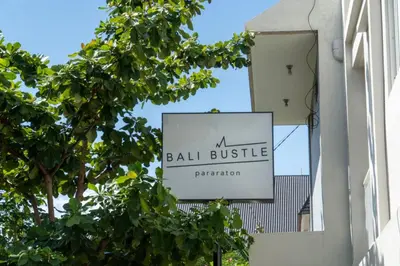 a sign for a ball hustle on the side of a building at Bali Bustle Pararaton Coliving and Coworking Space in Legian