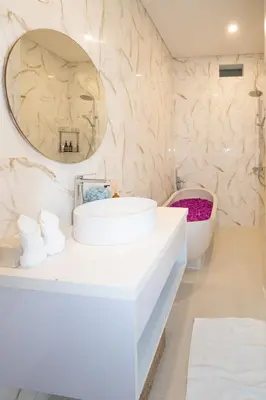 a bathroom with a white sink and a mirror at Letto 1 - Luxurious Villa with Pool in Canggu in Canggu