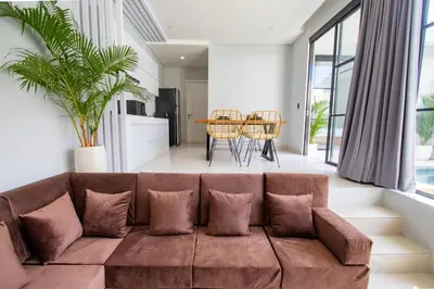 a living room with a couch and a table at Letto 1 - Luxurious Villa with Pool in Canggu in Canggu