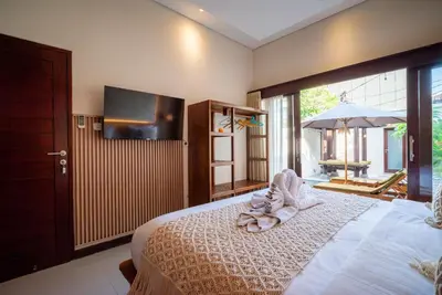 a bedroom with a bed with towels on it at Villa bella wilson II in Seminyak