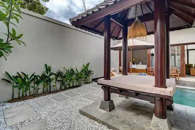 a bedroom in a villa with a swimming pool at Villa bella wilson II in Seminyak