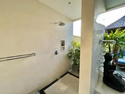 a lobby with a statue of a person on the wall at Classic tropical villa with private pool in Umalas in Dalung
