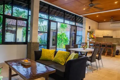 a living room with a couch and a table at VIlla Dafne in Seminyak
