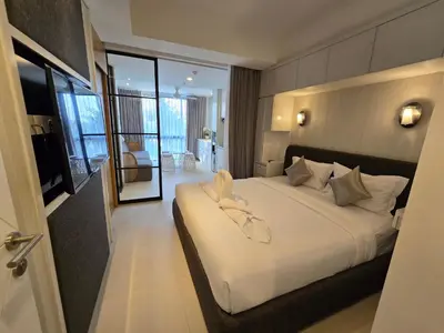 a hotel room with a large bed with white sheets at de' Asasta Apartment Benoa N508 in Nusa Dua