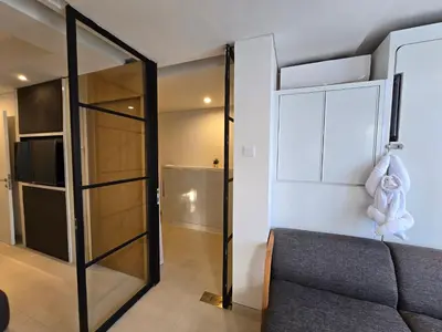 a room with a couch and a sliding glass door at de' Asasta Apartment Benoa N508 in Nusa Dua