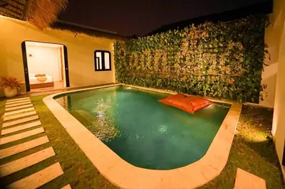 a swimming pool in the middle of a house at Villa Raaadha 3BR modern design villa center of seminyak in Seminyak