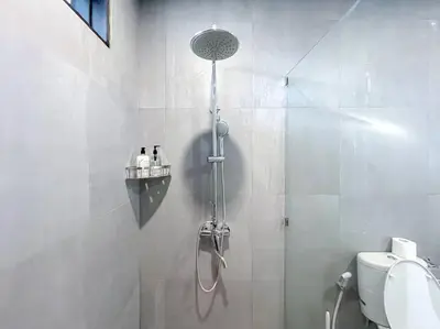 a shower in a bathroom with a glass door at Villa Raaadha 3BR modern design villa center of seminyak in Seminyak