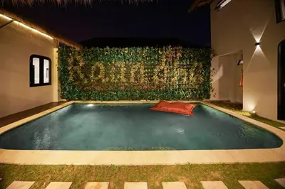a swimming pool in the middle of a house at night at Villa Raaadha 3BR modern design villa center of seminyak in Seminyak