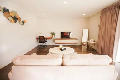 a living room with two white couches and a table at Villa Raaadha 3BR modern design villa center of seminyak in Seminyak