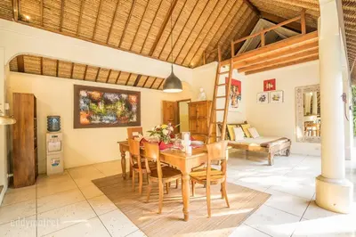 a dining room with a wooden table and chairs at Tropical 3BR villa in the heart of Seminyak in Seminyak
