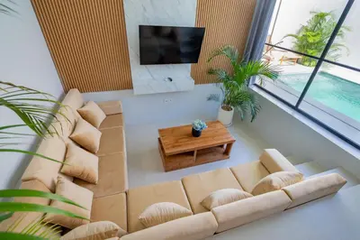 a living room with a couch and a tv at Letto 2 - Amazing 2BR Villa in Canggu with Private Pool in Canggu