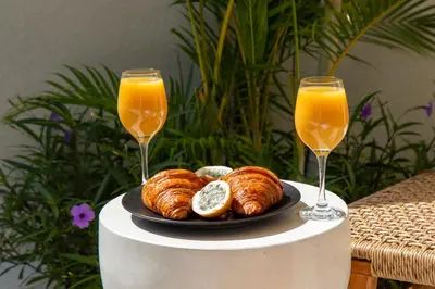 a plate of croissants and two glasses of orange juice at Letto 2 - Amazing 2BR Villa in Canggu with Private Pool in Canggu