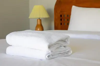 a stack of towels on a bed with a lamp at Letto 2 - Amazing 2BR Villa in Canggu with Private Pool in Canggu