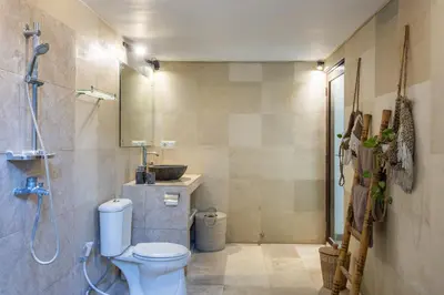 a bathroom with a toilet and a sink and a shower at 3 BR Villa in d' centre Seminyak in Seminyak