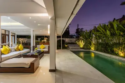 an outdoor living room with a swimming pool in a house at 3 BR Villa in d' centre Seminyak in Seminyak