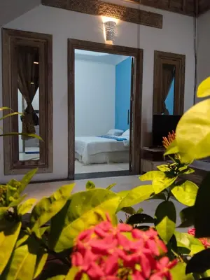 a room with a bedroom with a bed and a mirror at JOJOBY sunset villa in Seminyak