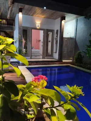 a swimming pool in the middle of a house at JOJOBY sunset villa in Seminyak