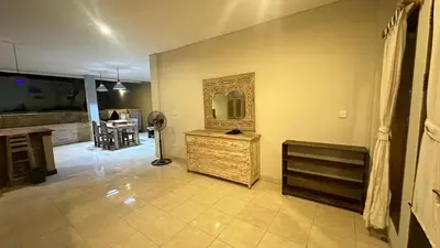 a living room with a mirror on the wall at Taman Giri House 3 Bedrooms Nusa Dua in Nusa Dua