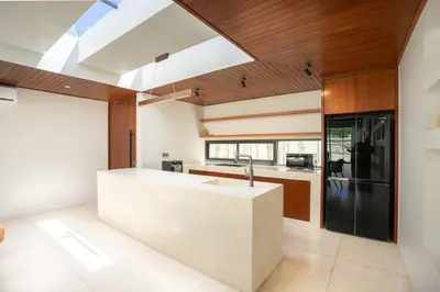 a kitchen with a white counter and a sink at Green Jimbaran Bay Villa III in Jimbaran