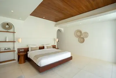 a bedroom with a bed and a wooden ceiling at Green Jimbaran Bay Villa III in Jimbaran