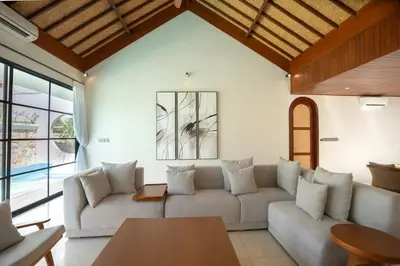 a living room with a couch and a table at Green Jimbaran Bay Villa III in Jimbaran