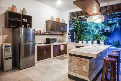 a large kitchen with a stainless steel refrigerator at Seminyak Beach Villa Ashira SUPERB Location in Seminyak