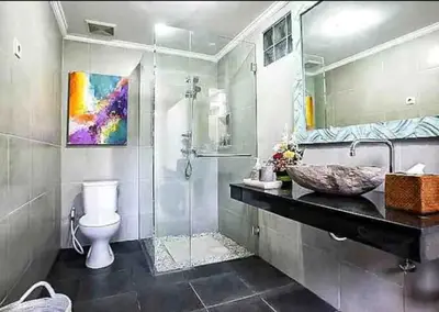 a bathroom with a shower and a sink and a toilet at Seminyak Beach Villa Ashira SUPERB Location in Seminyak