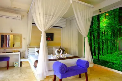 a bedroom with a canopy bed with a large window at Lavender Private Villa Kuta Bali in Kuta