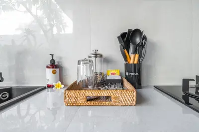 a kitchen counter with a tray with utensils on it at Villa Felicia Canggu By Moria in Canggu