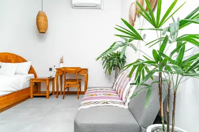 a living room with a couch and plants at Villa Felicia Canggu By Moria in Canggu