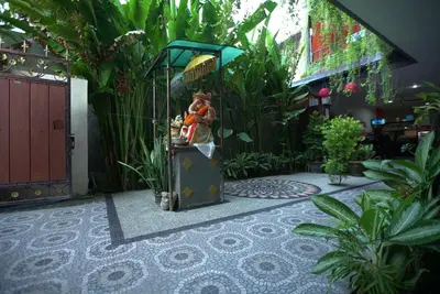 a garden with a stand with stuffed animals on it at Rena Segara House Kuta in Kuta