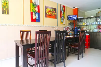 a dining room with a table and four chairs at Rena Segara House Kuta in Kuta