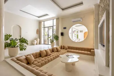 a living room with a large couch and a table at Casa De La Vida in Legian
