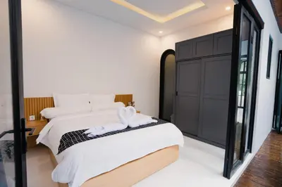 a bedroom with a bed and a large mirror at Sari Buana Villa Nusa Dua in Nusa Dua