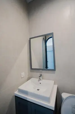 a bathroom with a white sink and a mirror at Sari Buana Villa Nusa Dua in Nusa Dua