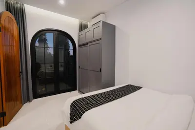 a bedroom with a white bed and a window at Sari Buana Villa Nusa Dua in Nusa Dua