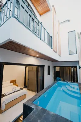 a bedroom and a swimming pool in a house at Sari Buana Villa Nusa Dua in Nusa Dua