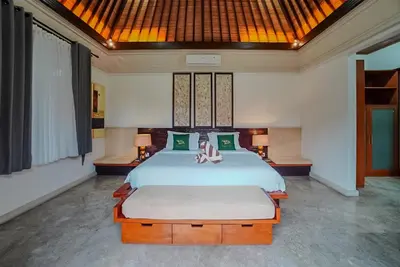 a bedroom with a large bed in a room at Villa Di Bucu, Canggu in Canggu