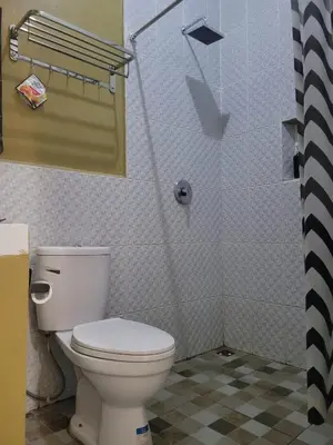 a bathroom with a toilet and a shower at 9 Residences Seminyak in Seminyak