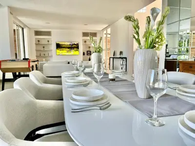 a dining room with a white table and chairs at 450 квадратных метров, Вид на Рисовое Поле и Лес in Kerobokan