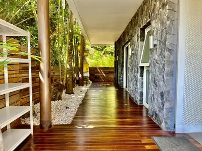 a hallway of a house with a stone wall at 450 квадратных метров, Вид на Рисовое Поле и Лес in Kerobokan