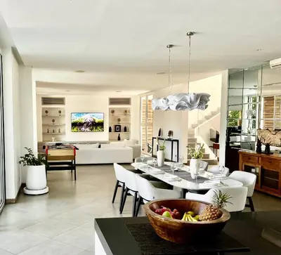 a dining room and living room with a table and chairs at 450 квадратных метров, Вид на Рисовое Поле и Лес in Kerobokan